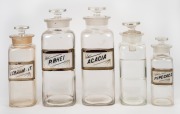 Group of five assorted antique glass apothecary jars, four of which with original labels "Acacia", "P. Rhei", "Feramm. Cit.", and "P. Ipecac. C.", all lids present, late 19th/early 20th century; the tallest 25cm overall. (5 items)