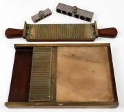 An antique pharmacist's pill press, together with two steel pill moulds, the longer of which 15cm; late 19th century. (3 items)