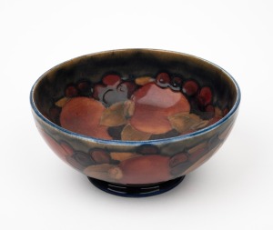 MOORCROFT "Pomegranate" pottery bowl on blue ground, impressed "Moorcroft, Made In England", 7cm high, 16cm diameter.