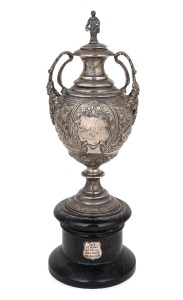 An antique cast sterling silver polo trophy, on ebonized wooden plinth, 19th century, 20cm high, 25cm high overall, 351 grams.