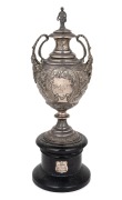 An antique cast sterling silver polo trophy, on ebonized wooden plinth, 19th century, 20cm high, 25cm high overall, 351 grams (not including base).