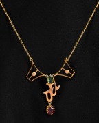 An antique 9ct gold negligee necklace set with green and red stones, early 20th century. Note: Later replacement 9ct gold clasp. 4.4 grams total.