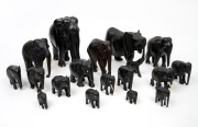 Group of seventeen assorted Ceylonese carved ebony elephant ornaments with bone tusks and toes, A/F, 20th century, ​​​​​​​the largest 20cm high.