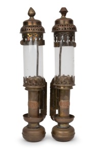 A pair of railway wall mounted candle lanterns with spring loading mechanism, brass, copper and glass, 19th/20th century, with applied copper label "G.W.R.", 35cm high.