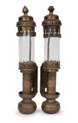 A pair of railway wall mounted candle lanterns with spring loading mechanism, brass, copper and glass, 19th/20th century, with applied copper label "G.W.R.", 35cm high.
