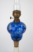 An antique oil lamp with blue overlay glass font, milk glass base, single burner and original chimney, 19th century, 55cm high overall. - 3