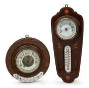 Two antique aneroid wall barometers with mercury thermometers, 19th/20th century, the larger 37cm high overall.
