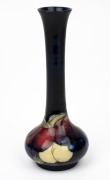 MOORCROFT "Wisteria" pattern English pottery stem vase on blue ground, impressed "Moorcroft, Made in England", ​​​​​​​18cm high.