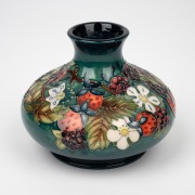 MOORCROFT floral pattern English pottery vase on green ground, circa 1990, limited edition signed by John Moorcroft, 10.5cm high, 13cm wide. - 2