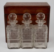 An antique mahogany cased campaign tantalus, housing three hobnail cut crystal decanters, 19th century, 26cm high, 30cm wide, 13cm deep. - 4