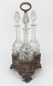 An antique silver plated decanter stand with three crystal decanters, 19th century, 46cm high.