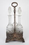 An antique silver plated decanter stand with three crystal decanters, 19th century, 46cm high. - 2