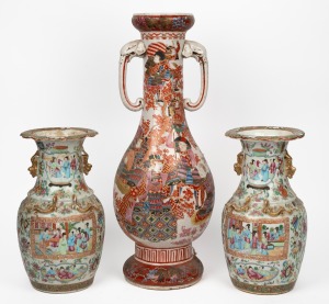 An antique Japanese porcelain mantle vase with samurai decoration and elephant handles; together with a pair of antique Chinese famille rose export ware porcelain vases, (A/F), 19th century, the largest 58cm high.