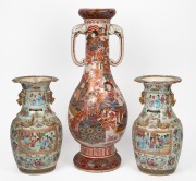 An antique Japanese porcelain mantle vase with samurai decoration and elephant handles; together with a pair of antique Chinese famille rose export ware porcelain vases, (A/F), 19th century, the largest 58cm high.