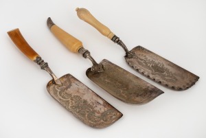 Three antique silver plated crumb trays with sterling silver collars and ivory handles, 19th century, the largest 36cm long.