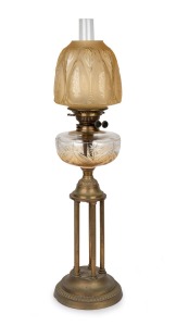 An antique banquet lamp with clear cut crystal font, black button double burner, acid etched peach shade and brass column bird cage base, 19th century, 77cm high overall.
