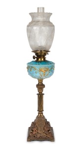 A banquet lamp, blue glass font with gilt and floral enamel highlights, black button double burner with acid etched shade and Corinthian column base, 19th century and later, 79cm high.