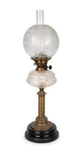 An antique oil lamp with clear cut crystal font, double black button burner, acid etched shade with brass and black glass base and chimney, 19th century, 76cm high.