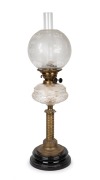 An antique oil lamp with clear cut crystal font, double black button burner, acid etched shade with brass and black glass base and chimney, 19th century, 76cm high.