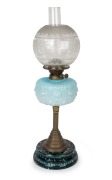 An antique oil lamp with blue glass font, double burner, acid etched shade and chimney on brass and mottled ceramic base, 19th century, ​​​​​​​​​​​​​​64cm high.