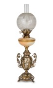 An antique English oil lamp with Royal Worcester porcelain font, single white button burner, acid etched shade and ornate pierced brass urn base on paw feet, 19th century, 75cm high.