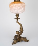 An oil lamp with floral peach glass font, acid etched floral shade, single black button burner and unusual cast metal Chinese acrobat base, 19th century and later, 70cm high. - 4