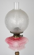 An antique oil lamp with square form pink glass font, double burner, acid etched glass shade and brass column base, 19th/20th century, ​​​​​​​67cm high. - 2