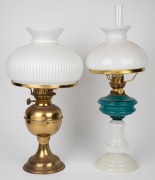 A brass oil lamp with milk glass shade; together with a blue and milk glass oil lamp with glass shade, 20th century, (2 items), 59cm and 48cm high.