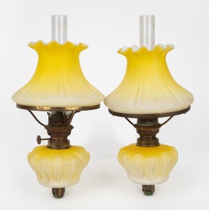 A pair of antique piano sconce oil lamps with lemon glass fonts and shades, 19th century, 31cm high overall.