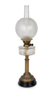 A vintage oil lamp with clear faceted glass font, reproduction acid etched shade, black button double burner, brass column and black ceramic base, 19th and 20th century, 72cm high.