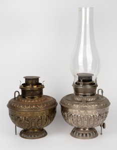 Two American pressed metal oil lamp bases, including one example with original chimney, 20th century, the larger 57cm high overall.