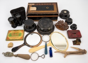 Antique turned timber plinths, hand-mirrors, binoculars, cash tin, magnifying glasses, pen work burl timber ornament, blue glass bottle, shoehorn and deer antler, 19th and 20th century, (qty), the tin 31cm wide.