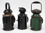 Three antique signal lanterns in black and green painted finish, 19th/20th century, ​​​​​​​the largest 32cm high overall. - 2