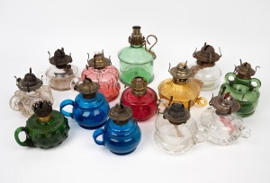 Thirteen assorted antique and vintage oil chamber lamps in various colours, 19th/20th century, the largest 20cm high.