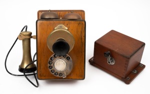 A vintage wall mount timber and brass rotary dial telephone, 20th century, 24cm high.