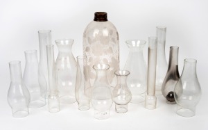 Fourteen assorted antique and vintage glass chimneys and shade, 19th and 20th century, the largest 30cm high.