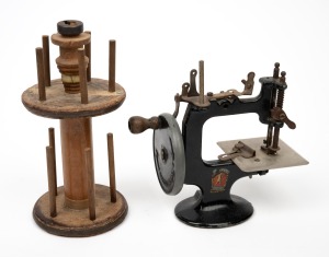 PETER PAN miniature hand-crank sewing machine; together with a folkart cotton spool holder, 19th/20th century, (2 items), ​​​​​​​18cm and 22cm high.