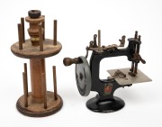 PETER PAN miniature hand-crank sewing machine; together with a folkart cotton spool holder, 19th/20th century, (2 items), ​​​​​​​18cm and 22cm high.