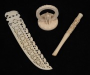 A Chinese carved ivory cigarette holder; together with an Indian carved ivory letter opener and elephant ornament, early to mid 20th century, (3 items), the largest 18cm long.