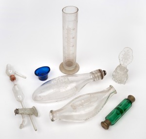 Antique and vintage medical glass bottles and equipment, blue glass eye bath, double ended green glass scent bottle and a cut crystal scent bottles, 19th/20th century, (7 items), ​​​​​​​the largest 27cm.