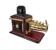 Large c. 1890s mahogany and brass MAGIC LANTERN with impressive triple-extension lens, tin chimney element, two side-opening doors with blue glass peepholes, and finely carved base; later retrofitted for electricity, dimensions approx. 46 x 30 x 64cm.