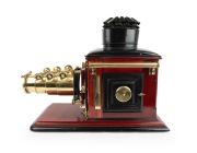 Large c. 1890s mahogany and brass MAGIC LANTERN with impressive triple-extension lens, tin chimney element, two side-opening doors with blue glass peepholes, and finely carved base; later retrofitted for electricity, dimensions approx. 46 x 30 x 64cm. - 4