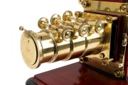 Large c. 1890s mahogany and brass MAGIC LANTERN with impressive triple-extension lens, tin chimney element, two side-opening doors with blue glass peepholes, and finely carved base; later retrofitted for electricity, dimensions approx. 46 x 30 x 64cm. - 5