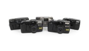 RICOH: Group of 1990s plastic point-and-shoot cameras, comprising Shotmaster Ultra Zoom, Shotmaster Zoom IIIP Panorama, Shotmaster Zoom IIIP Date Panorama, Shotmaster AF Date, and YF-20. (5 items)