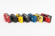 PLASTIC POINT-AND-SHOOT CAMERAS: Diverse 1980s-90s group comprising Hanimex Date, Hanimex 35D, Kafon KA-501, Longbeach PC-606, "Showbag Carousel", Yashica Electro 35 AF-Mini, and Yashica Partner AF (red). (7 items) - 2