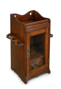 An antique English oak humidor smoker's cabinet with gilt metal fittings and drop-side pipe holders, late 19th century, 32cm high. - 2
