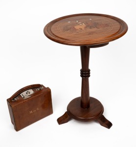An attractive vintage leather case with nickel plated fitting and embossed ownership monogram "M. DE S.", with hand-written family provenance note, circa 1920; together with an Indian occasional table with marquetry decorated top, (2 items), the case 18cm