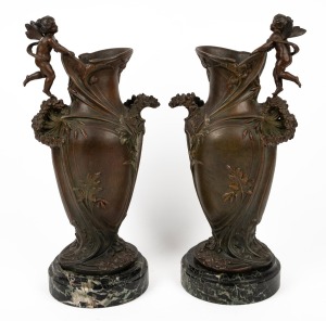 A pair of antique French spelter mantle urns with angels and floral decoration in the Art Nouveau style, on green marble bases, 19th/20th century, 43cm high.