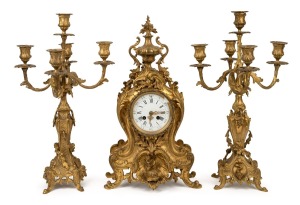 A three piece French gilt bronze clock garniture in the Rococo style, with eight day time and gong strike movement, 19th century, 47cm and 49cm high.