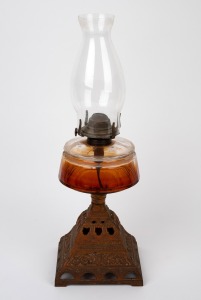 A vintage oil lamp with faceted clear glass font, cast metal base, burner and chimney, 20th century, 52cm high.